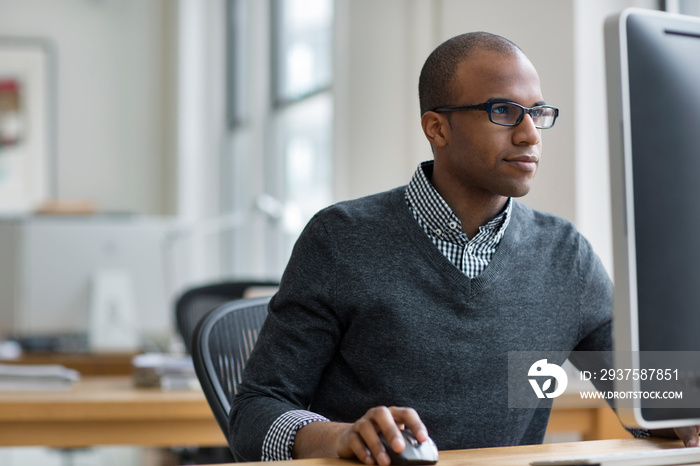 Businessman working on desktop computer in office