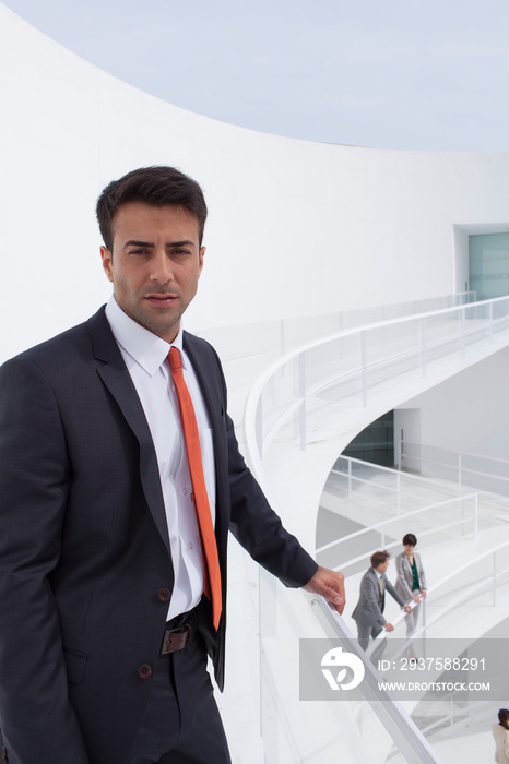 Portrait confident businessman on modern balcony