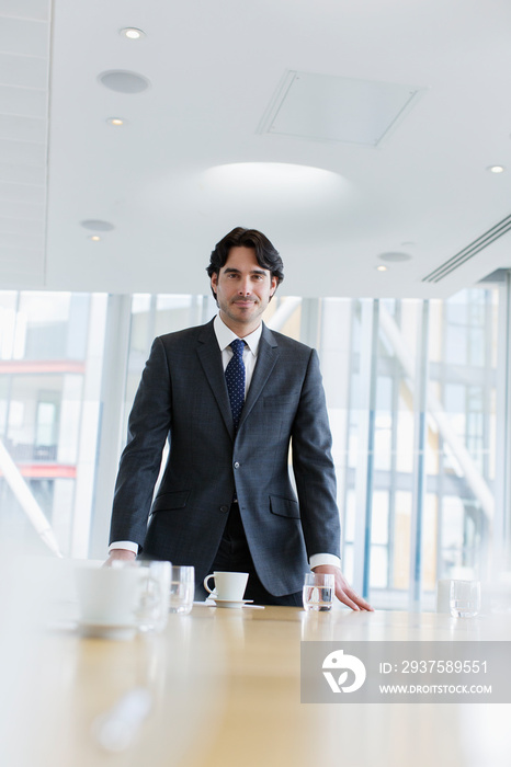 Portrait confident corporate businessman in conference room