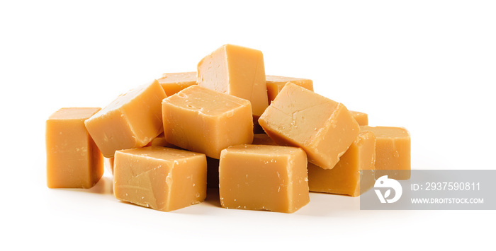 Heap of caramel vanilla fudge isolated on white background. Fresh tasty candies made of milk and sug