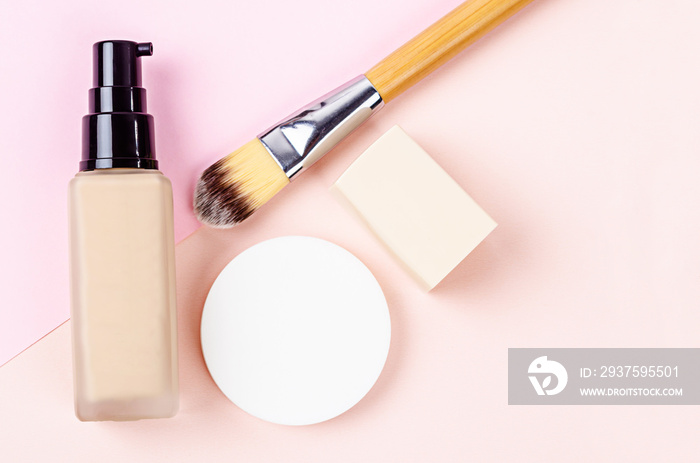 Liquid foundation makeup with brush and sponge.