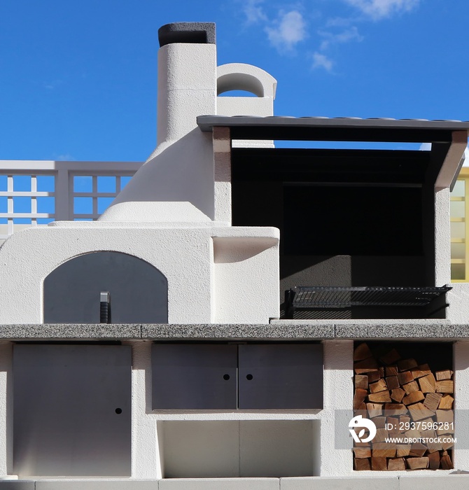 Stylish outdoor barbecue oven made of white plaster