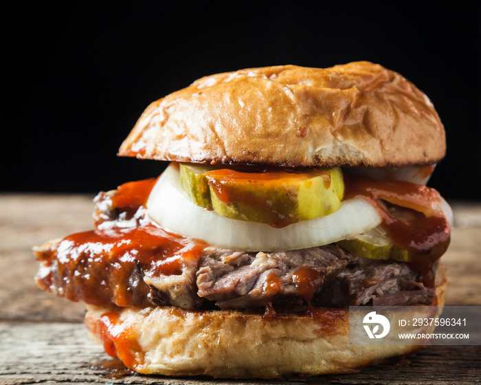 Smoked brisket sandwich with pickles, onions and bbq sauce