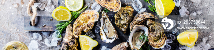 top view of delicious oysters on ice cubes and wine glass