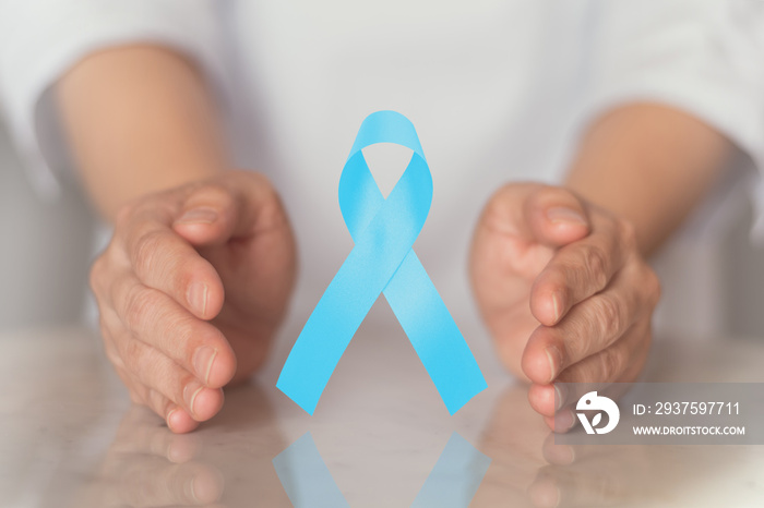 Light blue ribbon awareness in hand for Prostate cancer , lymphedema ,Mens Health in November.