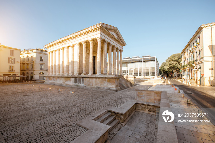 View on the ancient Roman temple Maison Carree during the sunny morning in Nimes in the Occitanie re