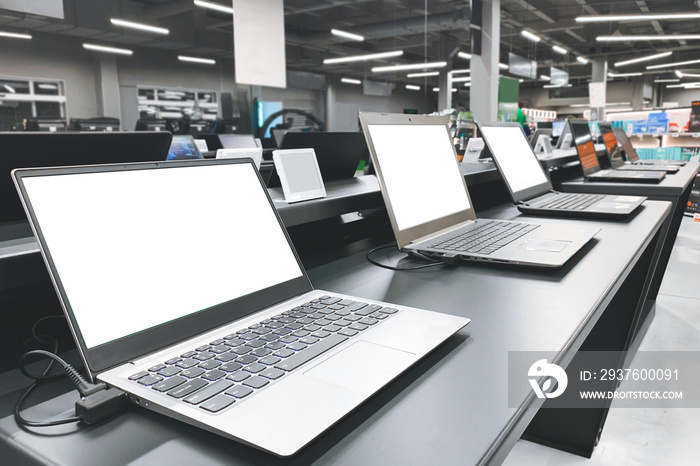 Laptops in a modern technology store. Department of computers in the electronics store. Choosing a l