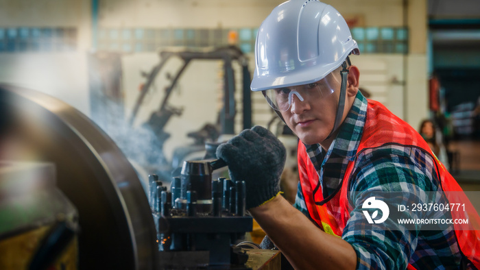 industrial background of caucasian mechanics engineer operating lathe machine for metalwork in metal