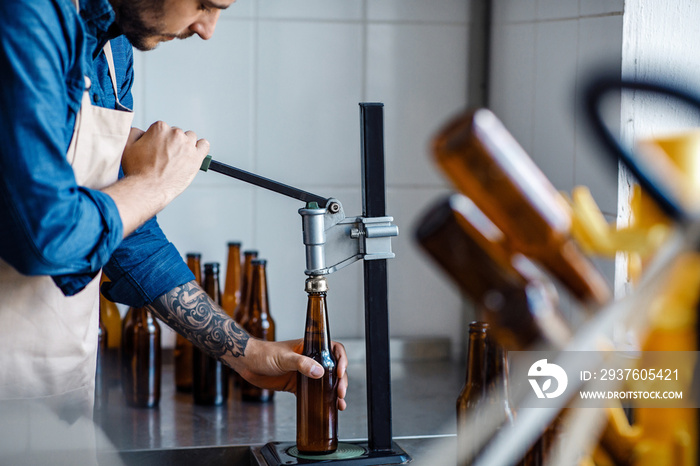 Drink production, employee works on beer manufacturing, craft plant