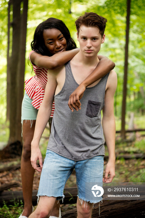 Interracial couple together in forest
