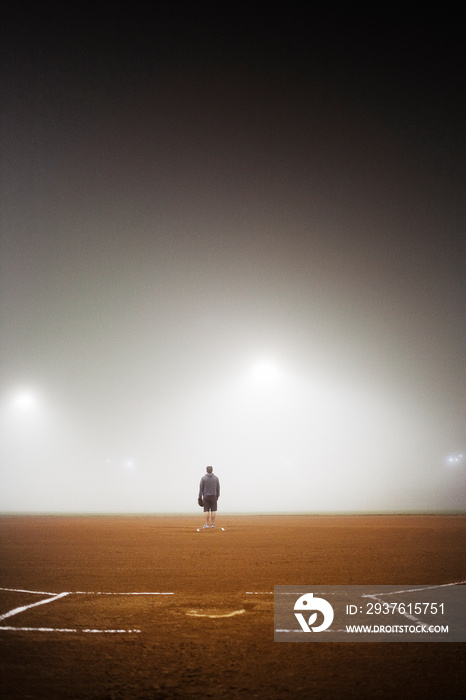 Rear view of man standing in baseball field