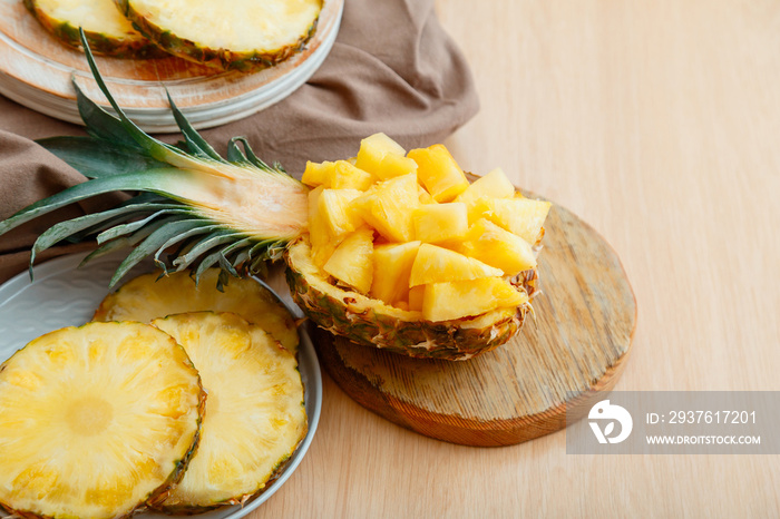 Chopped pineapple salad in half pineapple. Fresh delicious pineapple cut into pieces. Tasty summer p