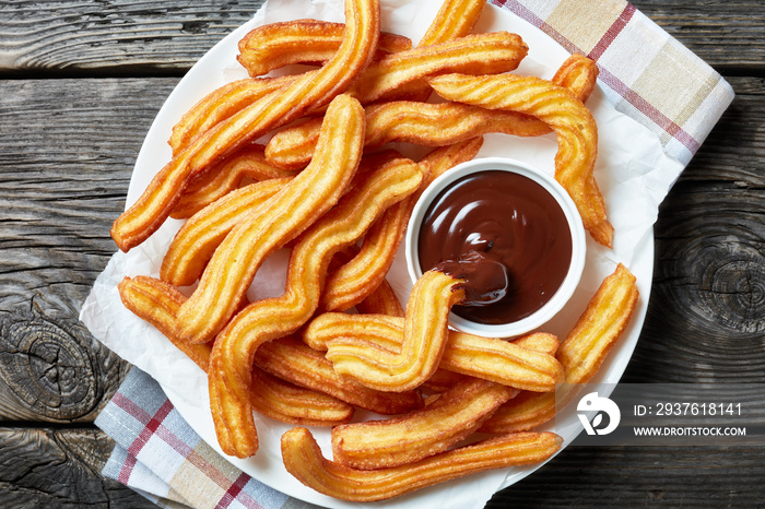 close-up of churros on plate with chocolate sauce