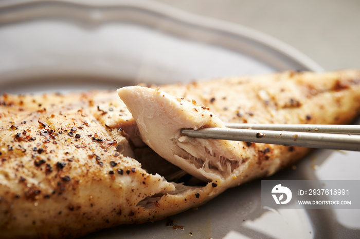 Grilled mackerel fish, eating with chopsticks