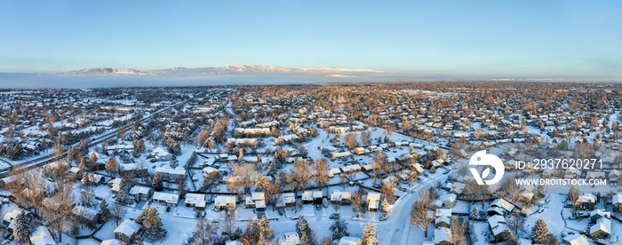 winter sunrise over residential area of Fort Collins and Rocky Mountains foothills in northern Color