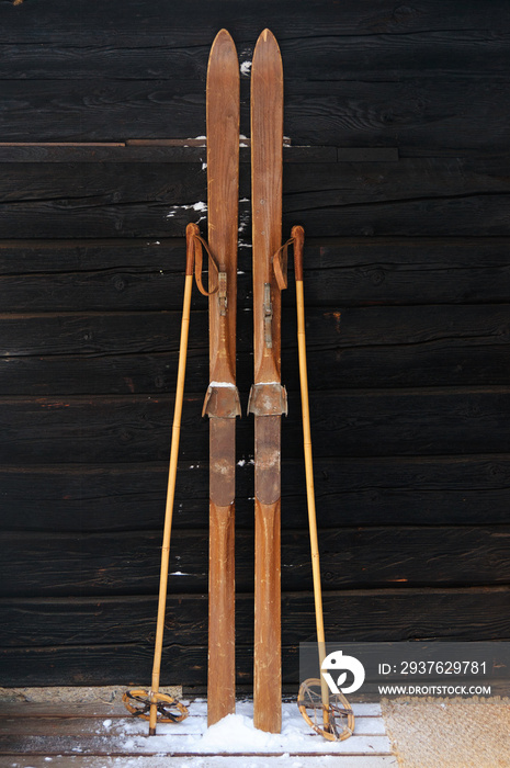 Photo of vintage old wooden skis on the terrace of a country house