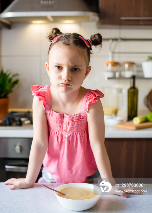 Little Girl doesn’t want to eat vegetable puree soup. Healthly food. Vegetarian soup