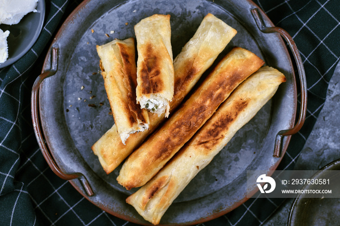 Fresh baked Börek, a baked filled pastries made of a thin flaky dough filled with sheep milk chees