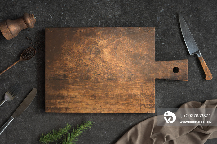 Old Wooden cutting board and Kitchen utensils on a Concrete background, Free space for your text