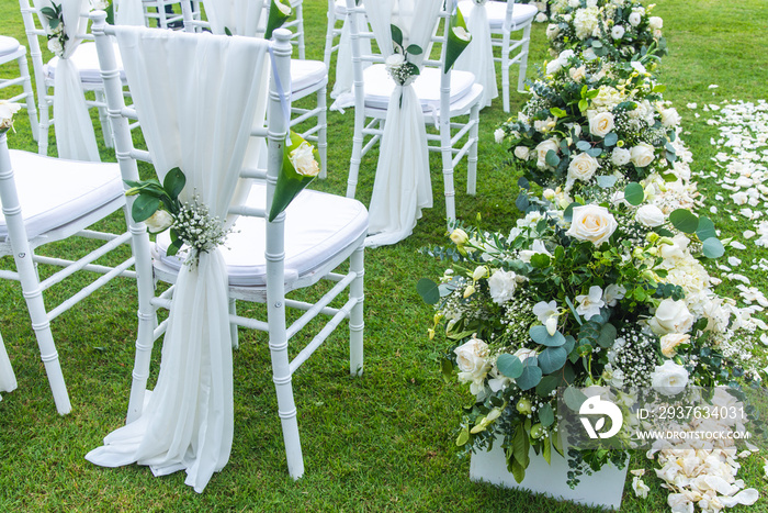 Chair decorated with flowers in Wedding ceremony.