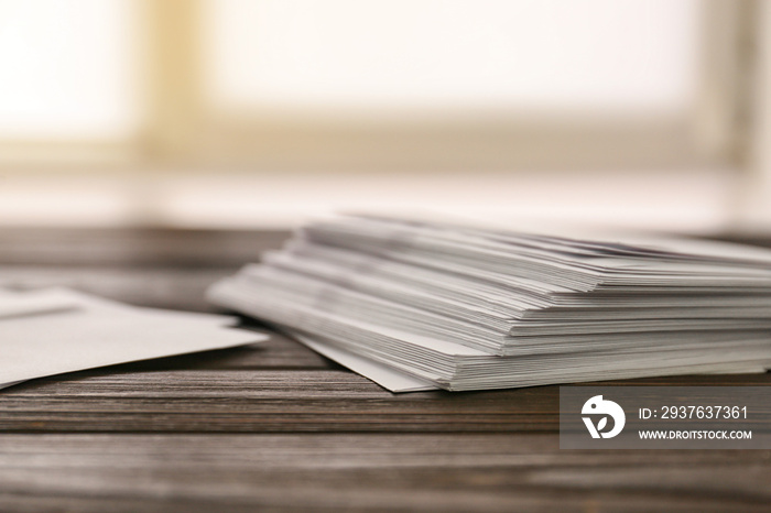 Many paper envelopes on table