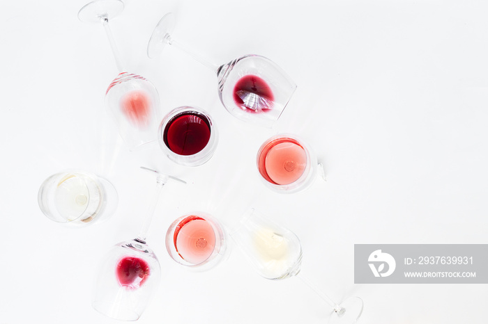 Glasses with different wine bordeaux, red, rose and white on white background. Beautiful wine variet