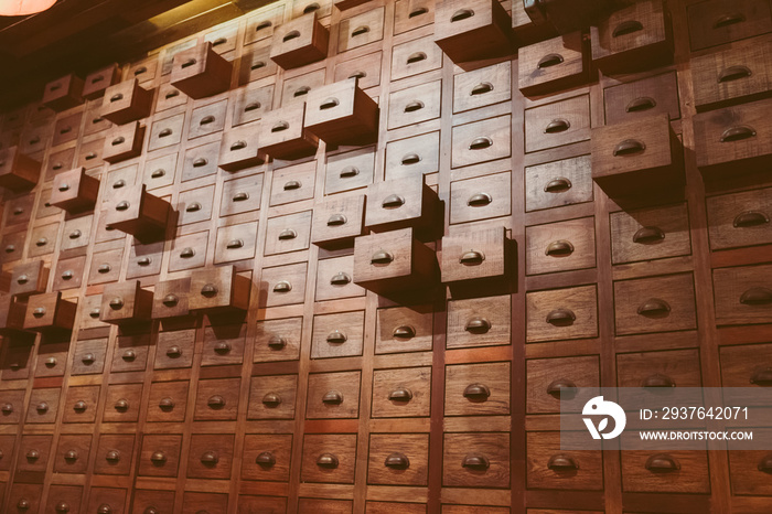 Old wooden textured drawers background in chinese herbal medicine shop in china.Vintage asian object