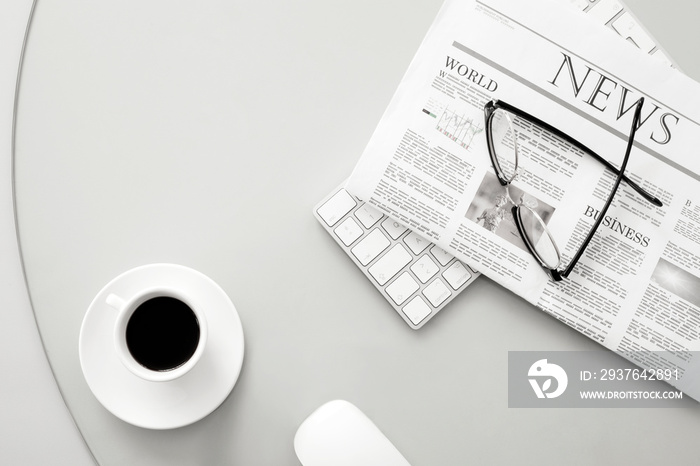 newspaper and eyeglasses over office desk