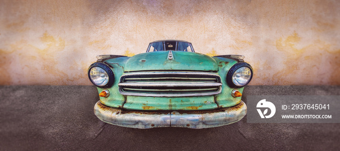 The headlight of the old beautiful car on the background of a concrete wall. Copy space. Concept ban