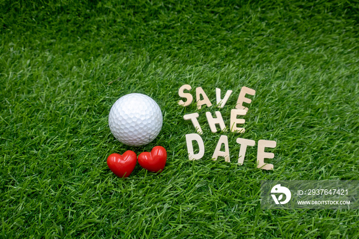 Golf ball with save the date word are on green grass