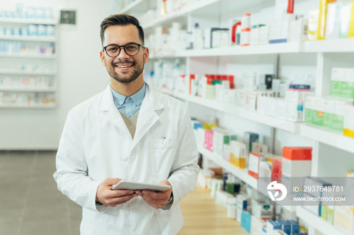 Portrait of a handsome pharmacist working in a pharmacy