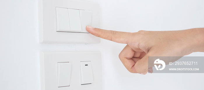 Closeup Male finger is turn on or off on light switch on white wall at home. Energy Saving, power, e