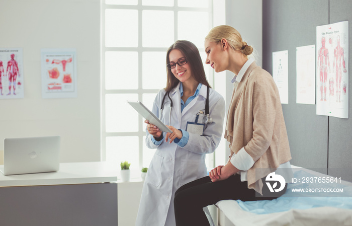 Doctor and patient discussing something while sitting at the table . Medicine and health care concep