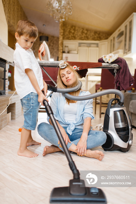 Little boy wrapped the housewife with a hose