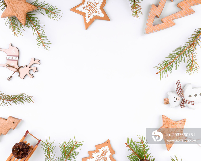 Christmas background frame of fir twigs, wooden zero waste home decoration: reindeer, stars and chis