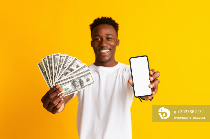 Excited african man holding lots of money in dollar currency
