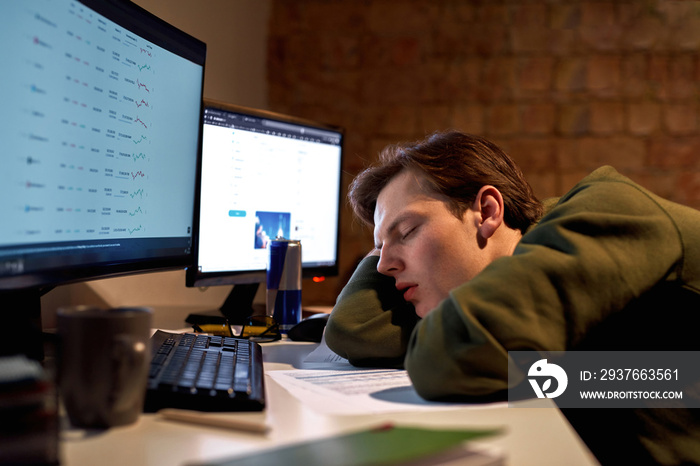 Tired male trader or broker sleeping at desk