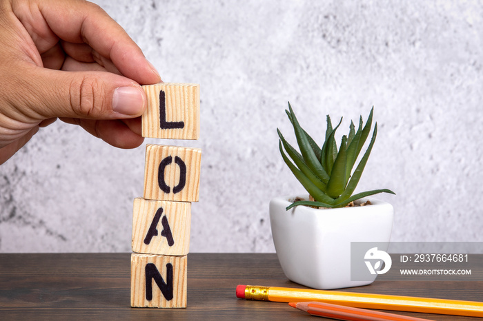 Loan. Credit, Real Estate and Business concept. Wooden letters and pencils on the office desk