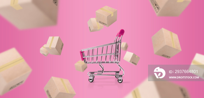 trolley or cart and paper boxes parcel falling and flying on pink pastel background. concept shoppin