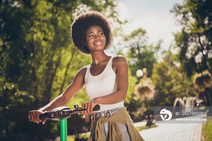 Portrait of her she nice-looking attractive pretty cheerful cheery girl riding kick scooter bike spe