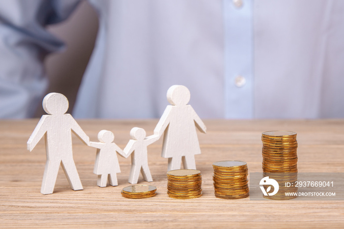 Growth of the family budget. Man holds family from his father, mother, daughter and son against the 