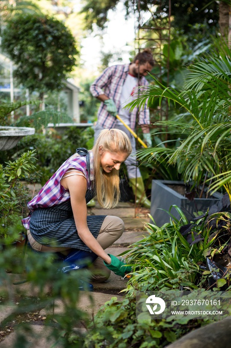 Happy gardener planting in community garden