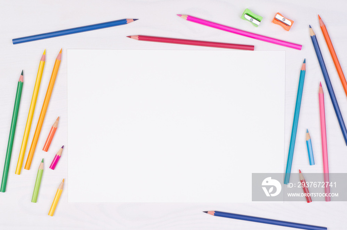 Blank piece of paper with colorful pencils on kids desk, top view with copy space