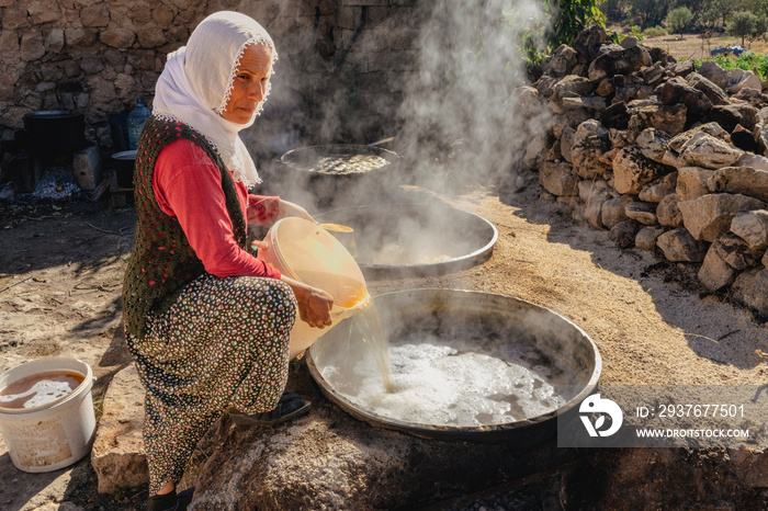 Grape juice is boiled on a wood fire