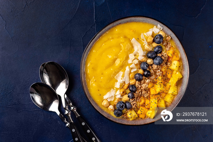 Top view of mango smoothie bowl with fruits