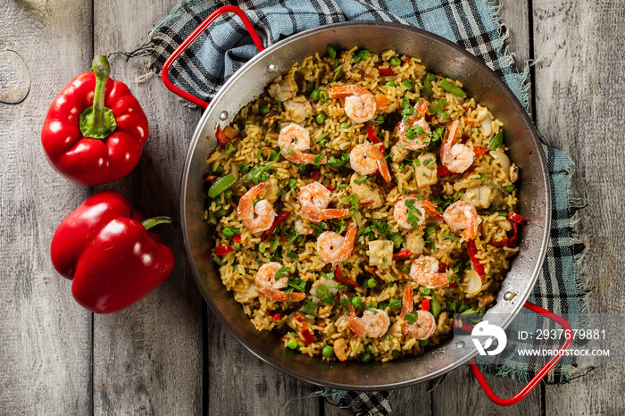 Traditional seafood paella with shrimp, fish and chicken seved i