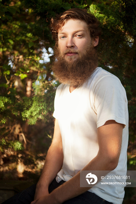 Portrait of man sitting in forest