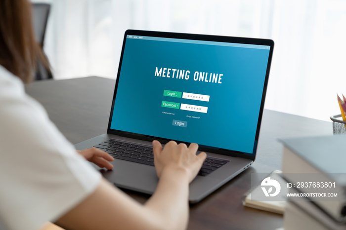 Woman hand using log in to the online meeting website on laptop at house. Concept working from home.