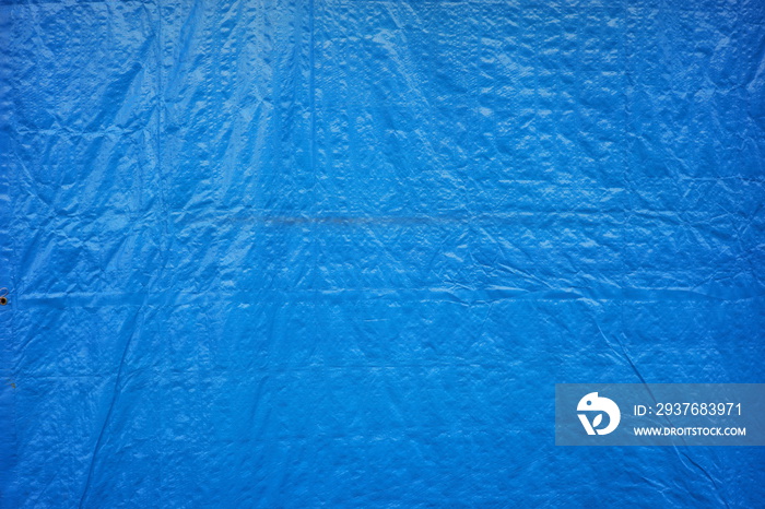 details of the thick tarpaulin used by traditional market traders to withstand rain and sun. blue ta