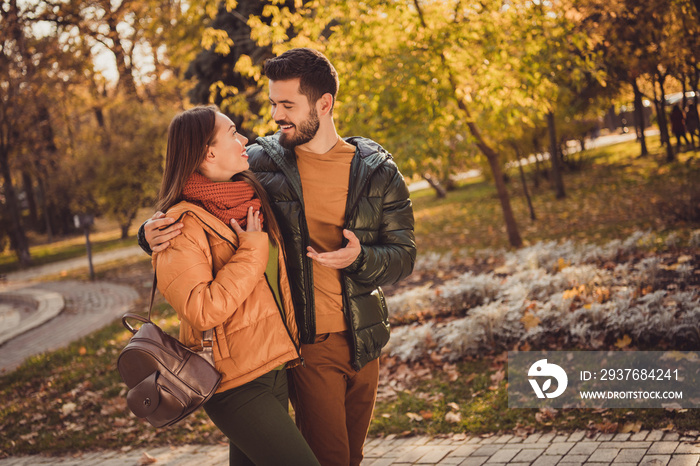 Photo of positive couple go in weekend fall outside park forest speak wear october rucksack yellow c